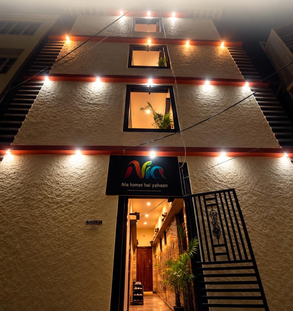 A Nia Studio lit up at night, with the Nia sign over the entrance